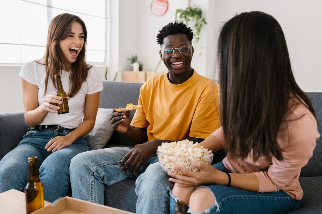 Group of young friends having fun enjoying time together at home