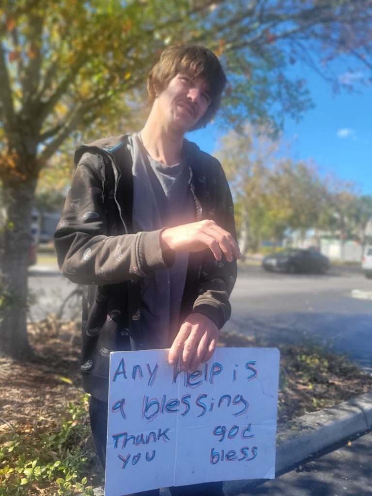 Homeless man with sign